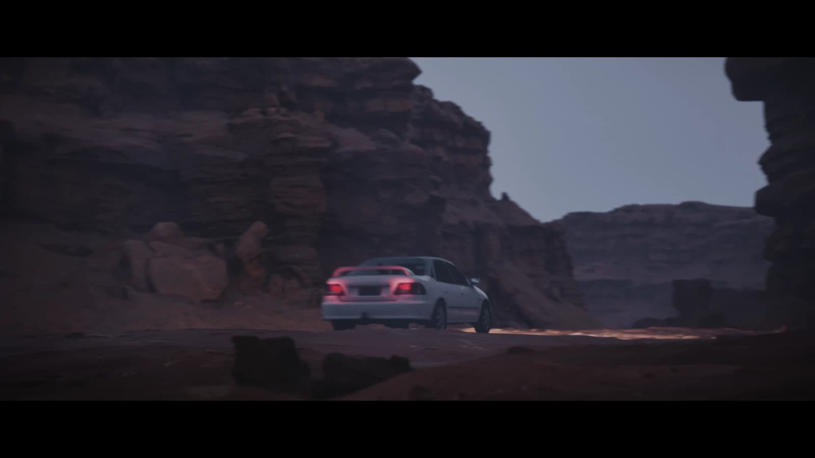 A car driving through the rocky canyon in The Final Drift
